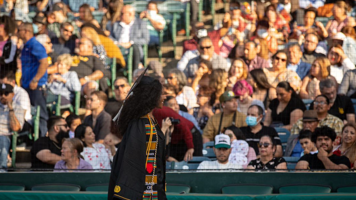 Graduate walking at stadium