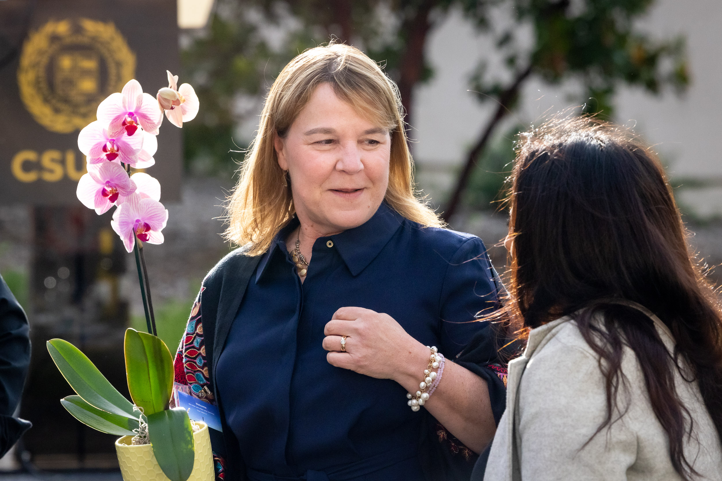 Karen Baker standing near flower