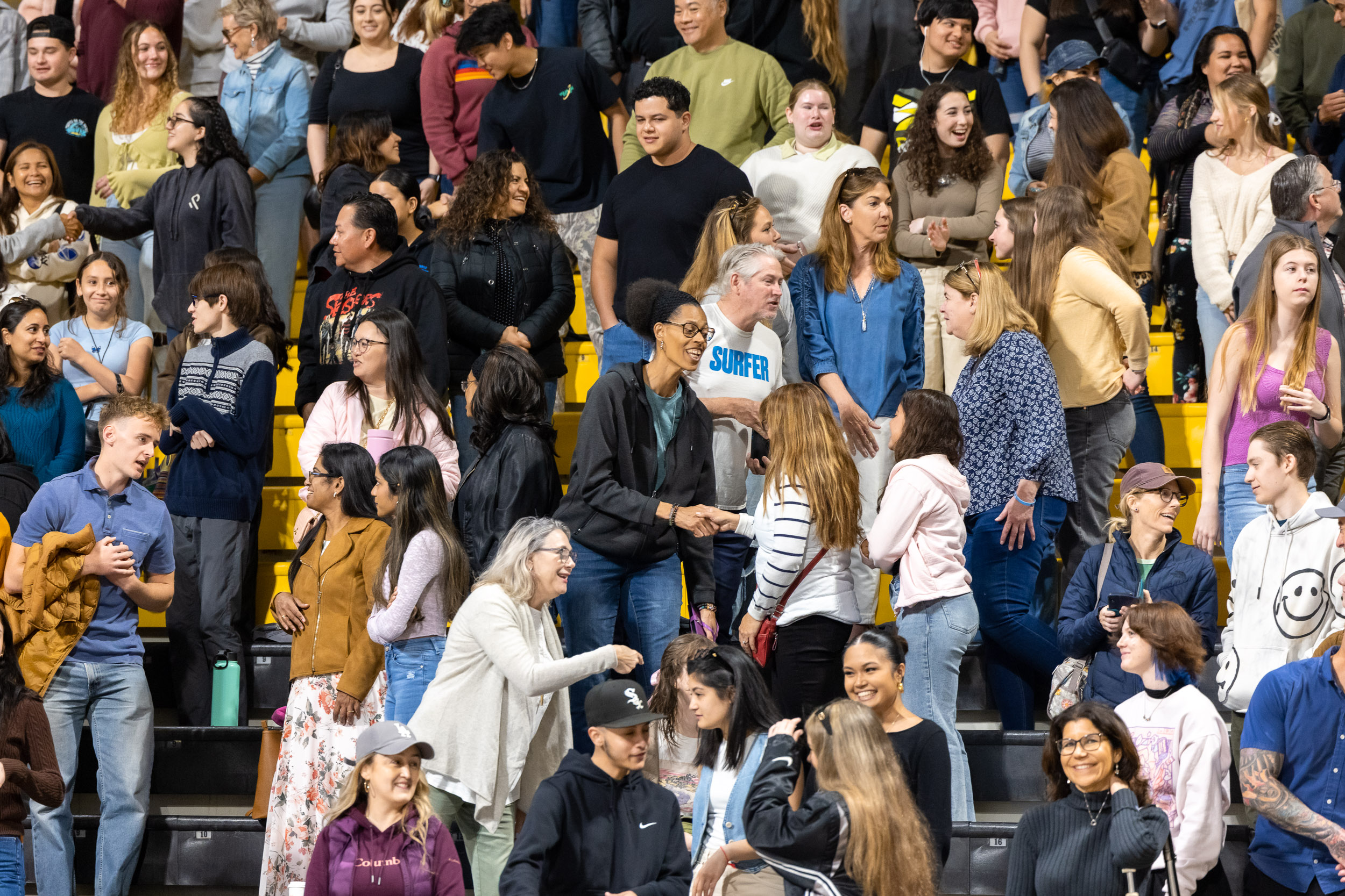 Students shaking hands in a crowd