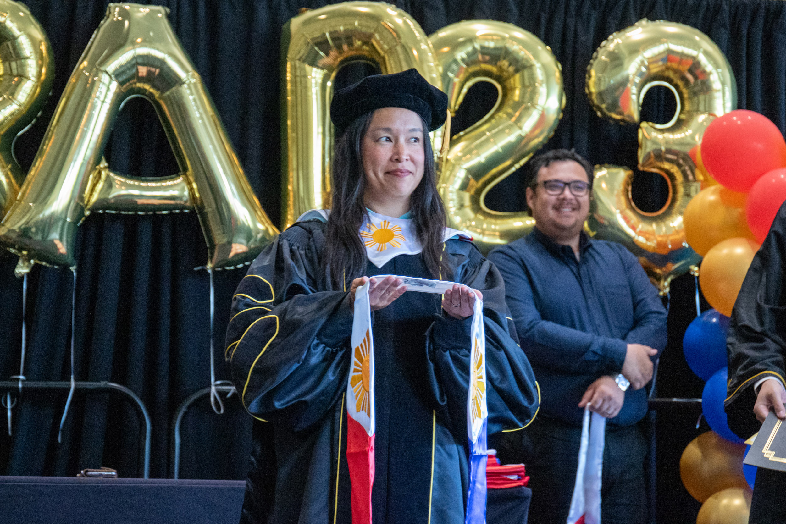 Faculty holding sash