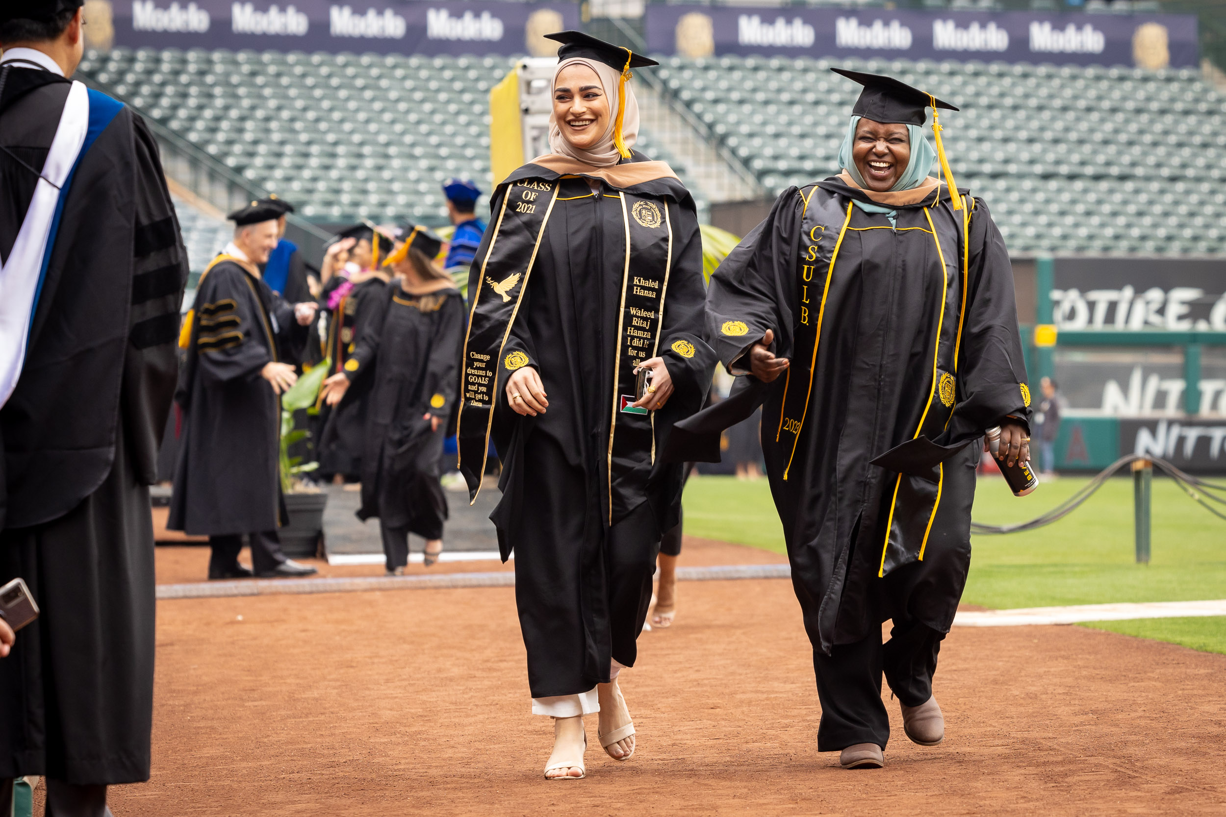 Two students with hijabs celebrate