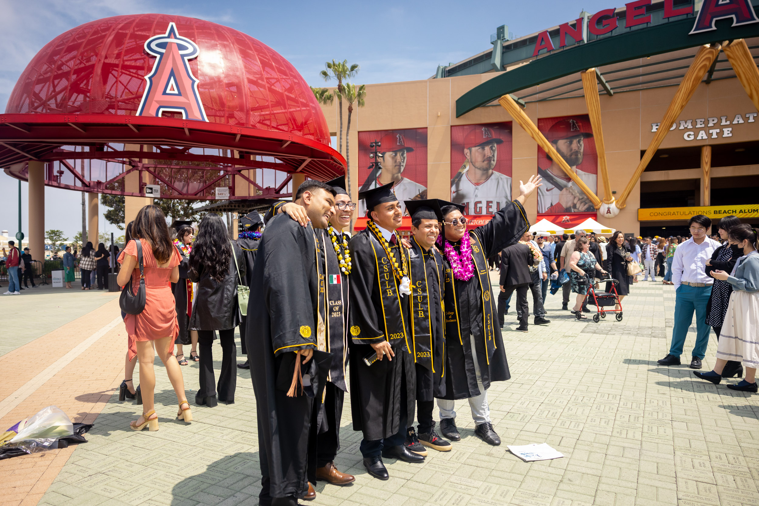 Family stands in front of big red Angels cap