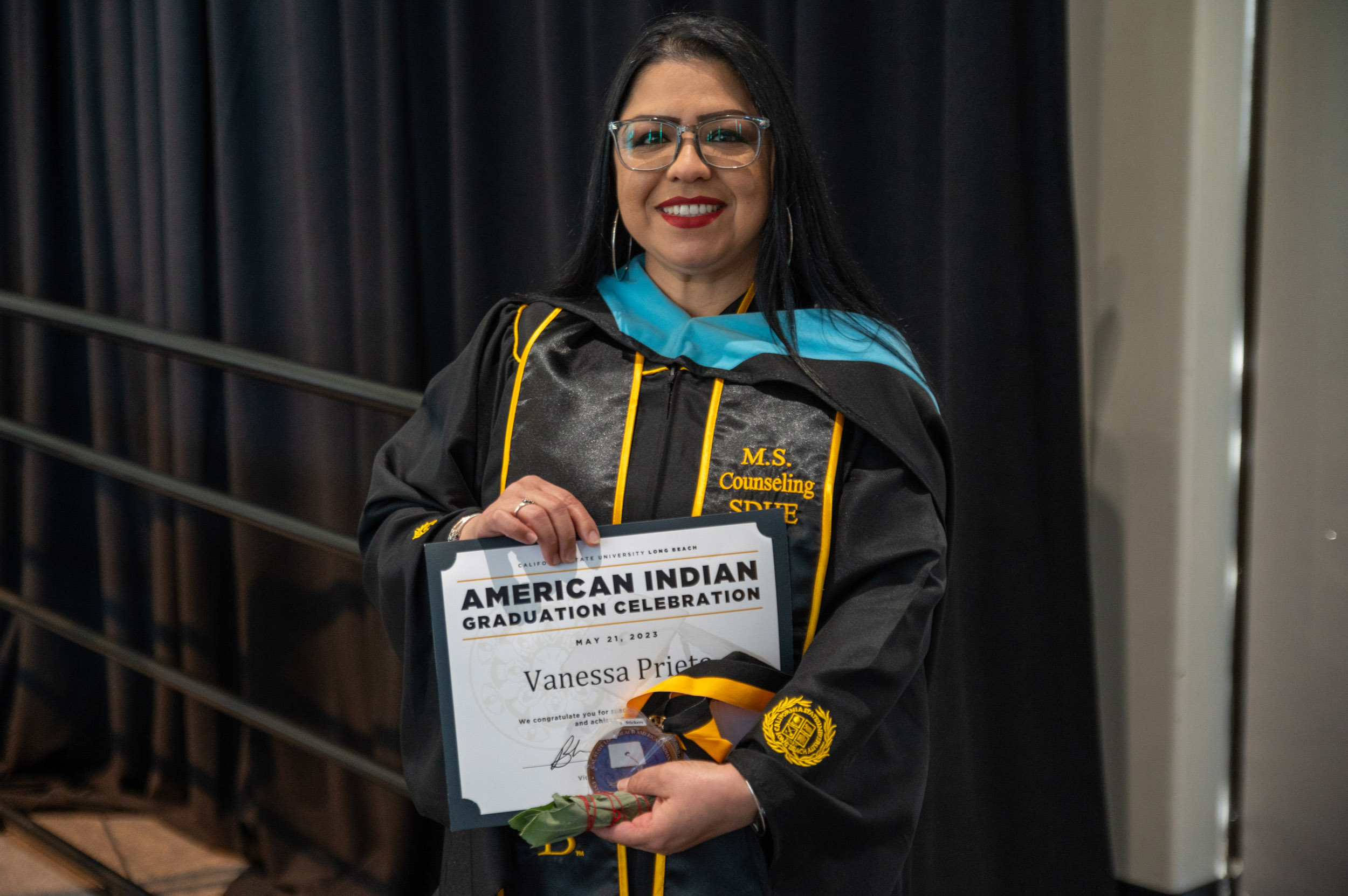 American Indian student holding certificate