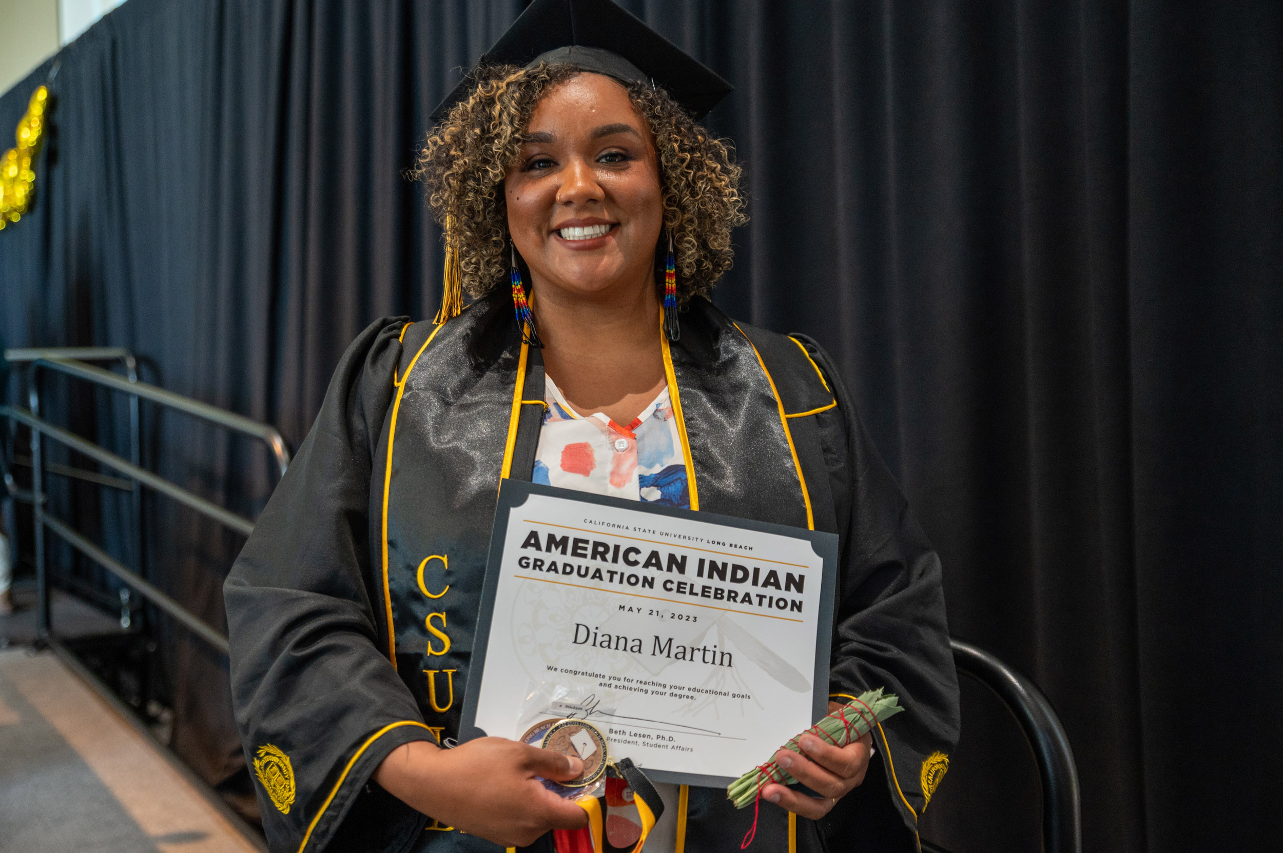 American Indian student holding certificate