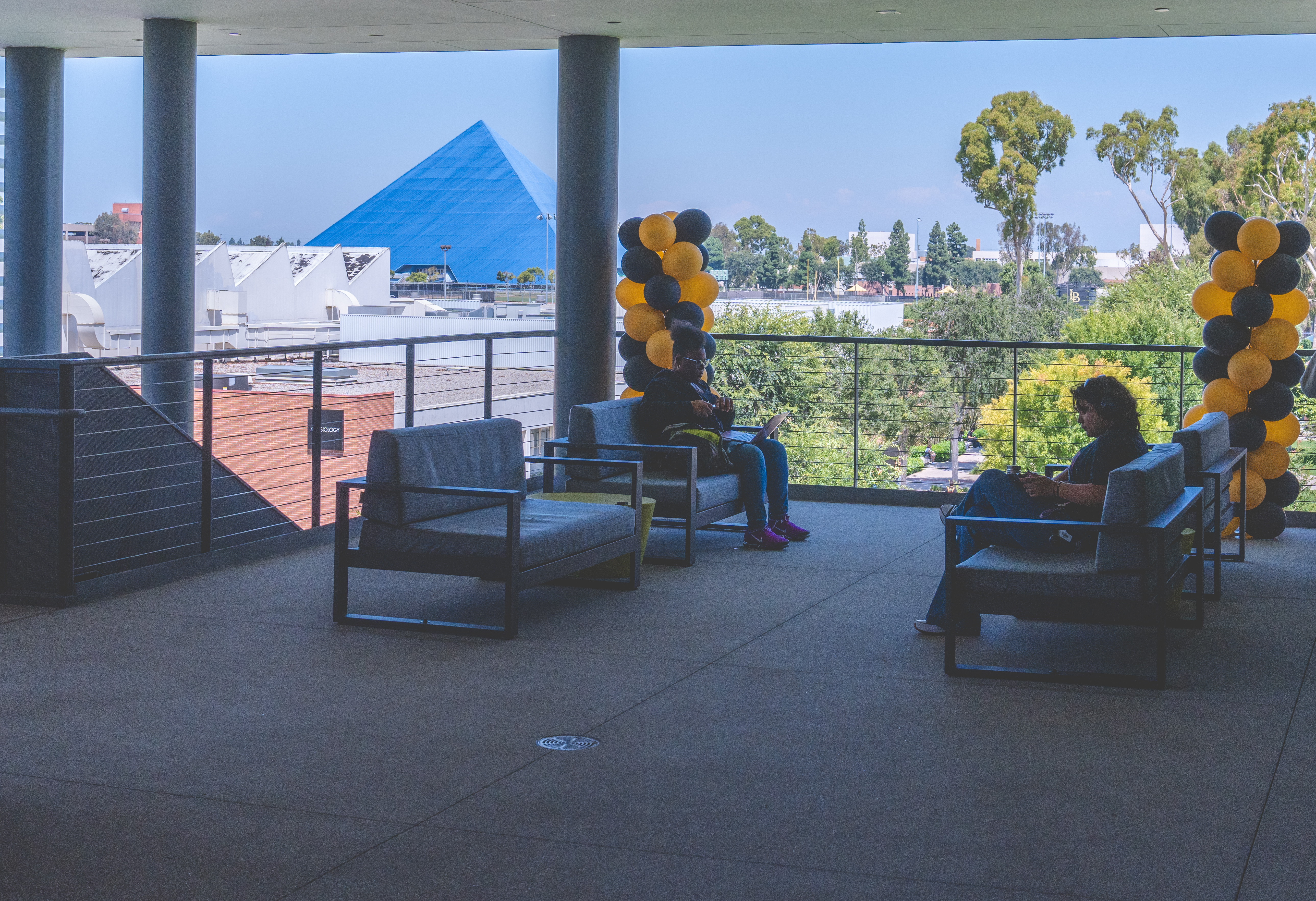 Beach XP students sit on the outdoor patio of the CPaCE building. 