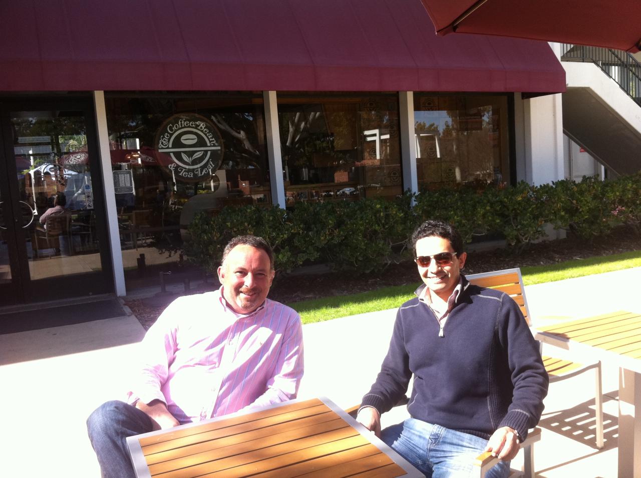 Alumni sit infront of Coffee Bean