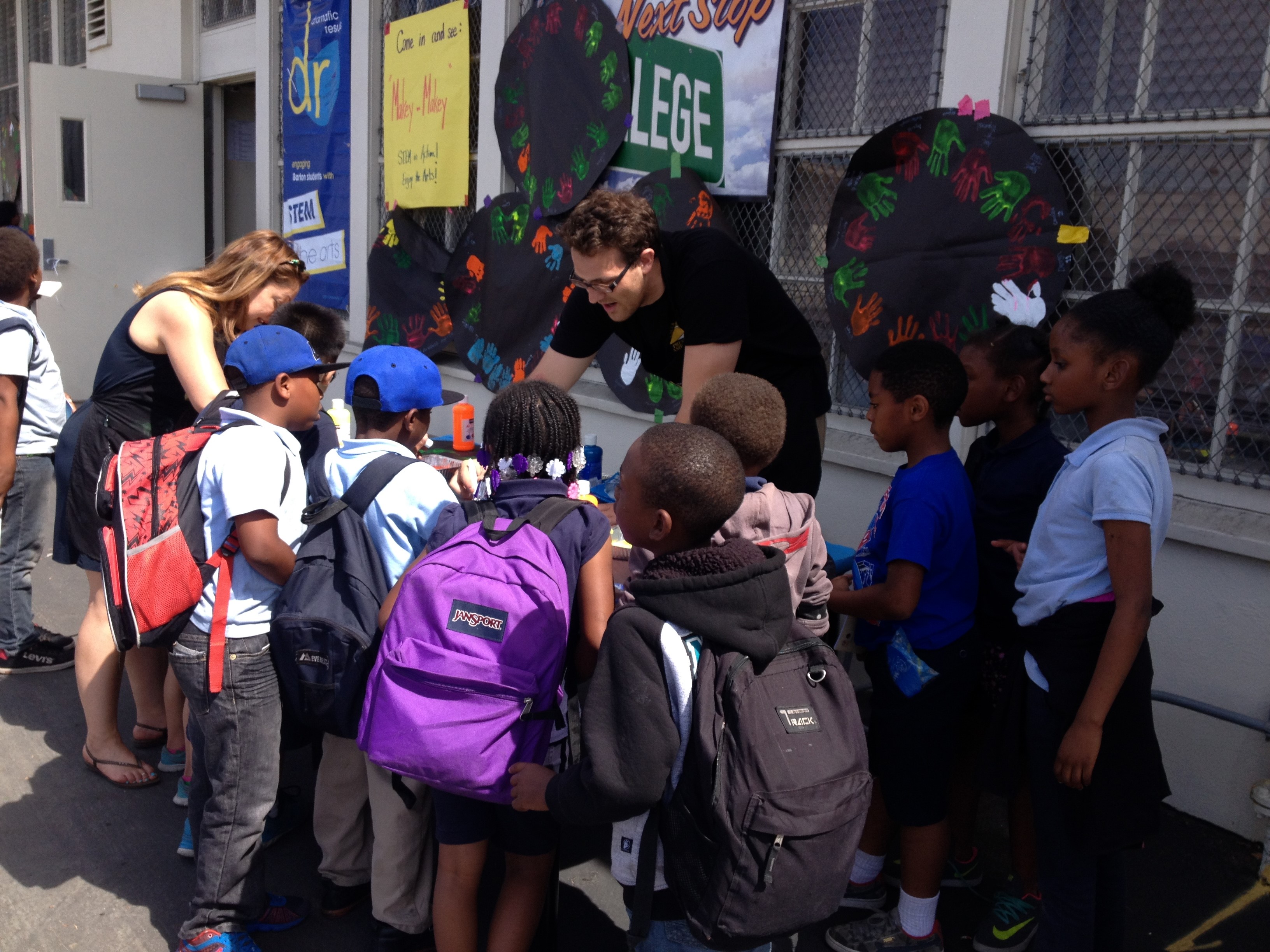 President ambassador helping elementary school children 