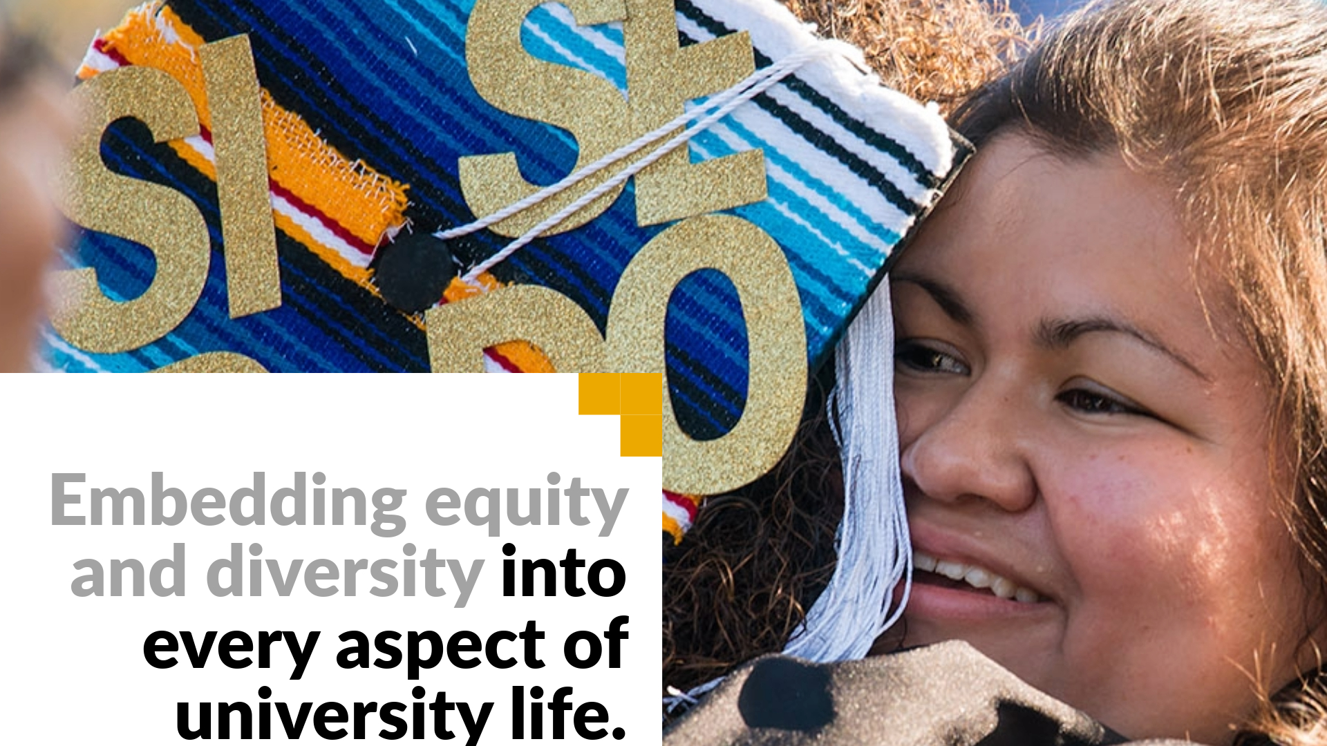 Embedding equity and diversity into every aspect of university life. Image shows a woman embracing a graduate at commencement.