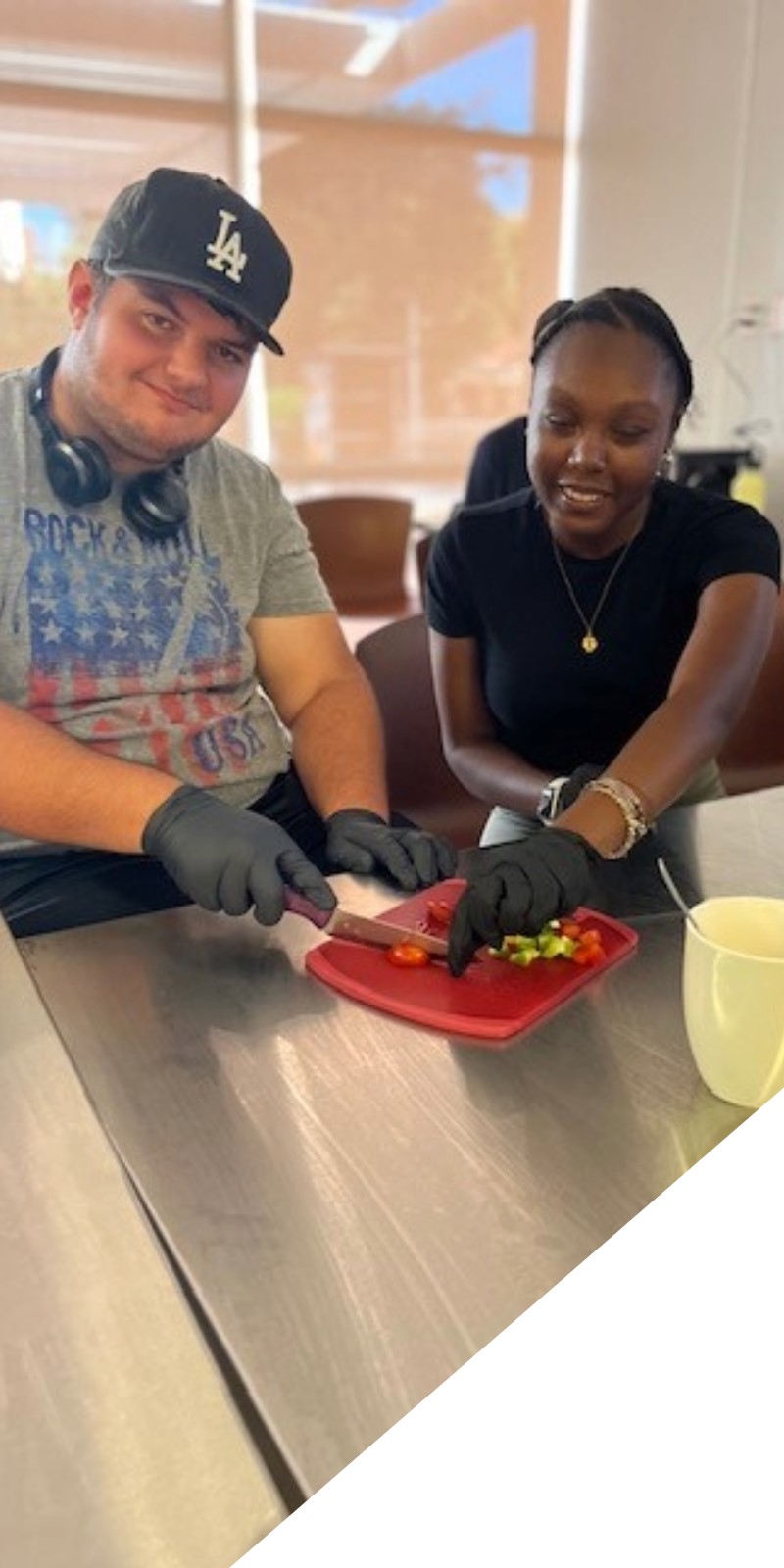 Think Beach students participated in life-skills workshops including a cooking class this year. Pictured are mentee Steven Perez and mentor Ashley Harris.
