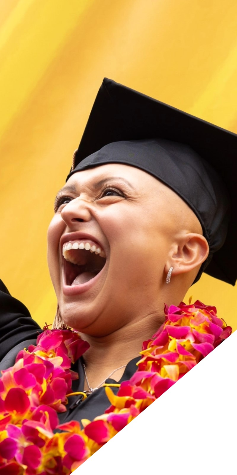A student in cap and gown at graduation.