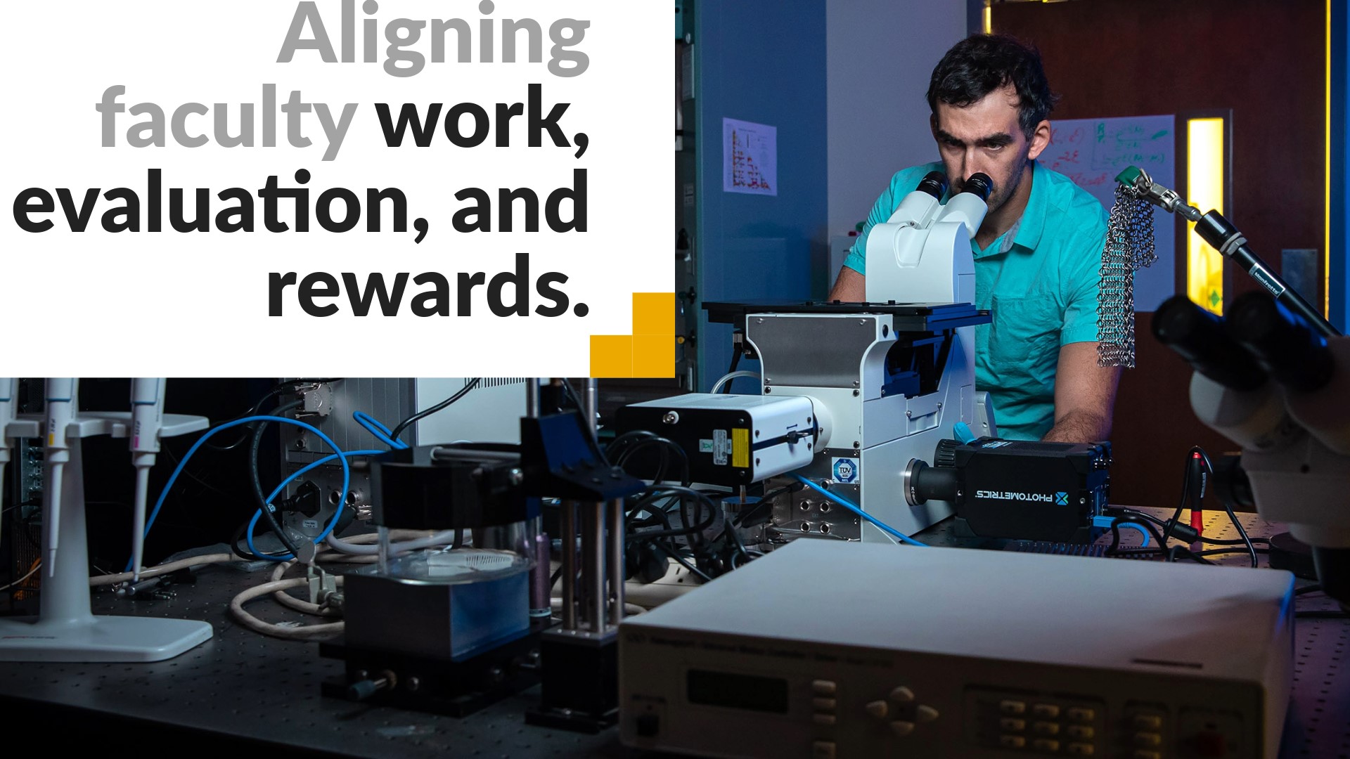 Aligning faculty work, evaluation, and rewards. Image shows a professor looking into a microscope.