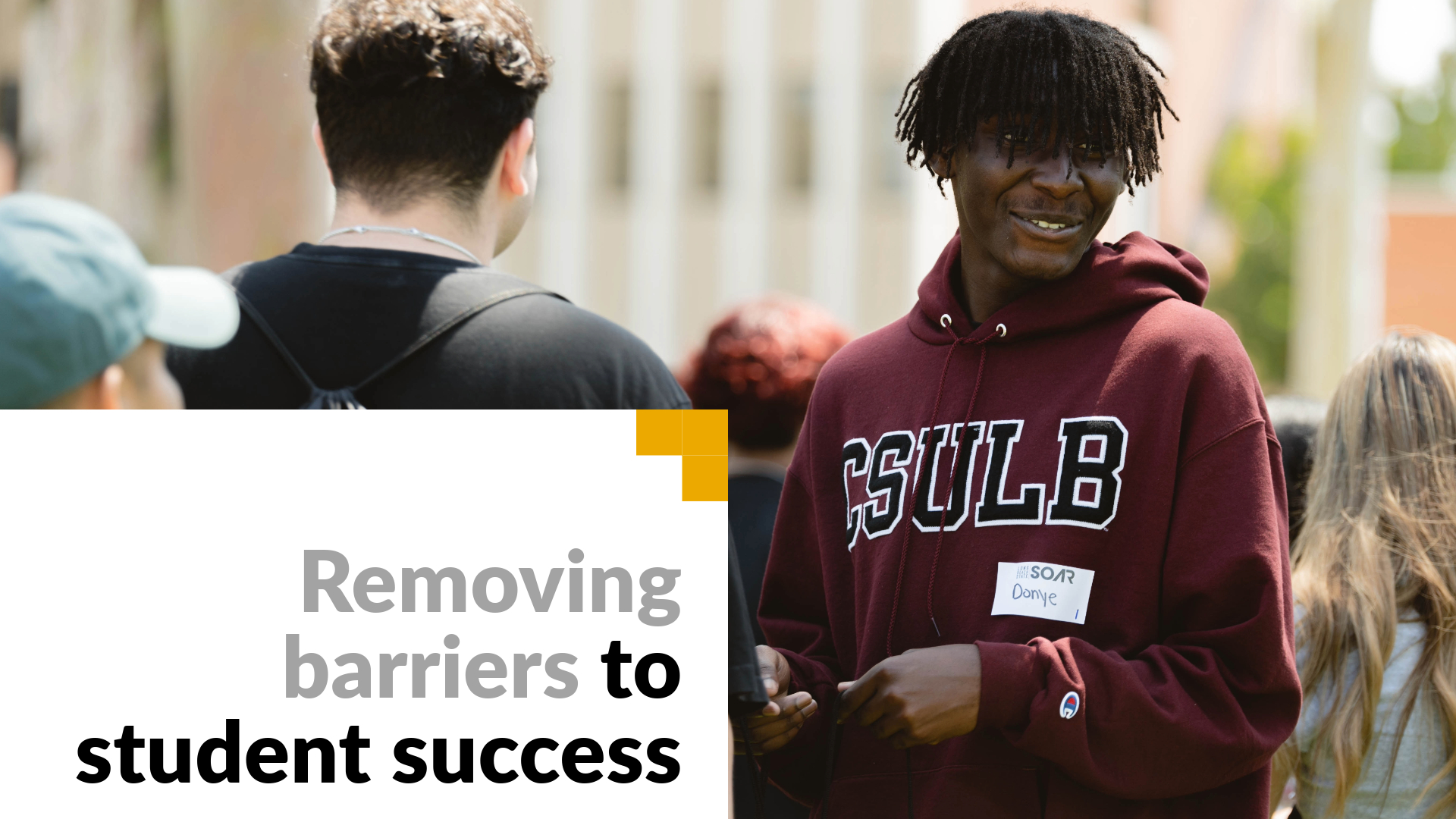 Removing barriers to student success. Image shows a student at orientation. 