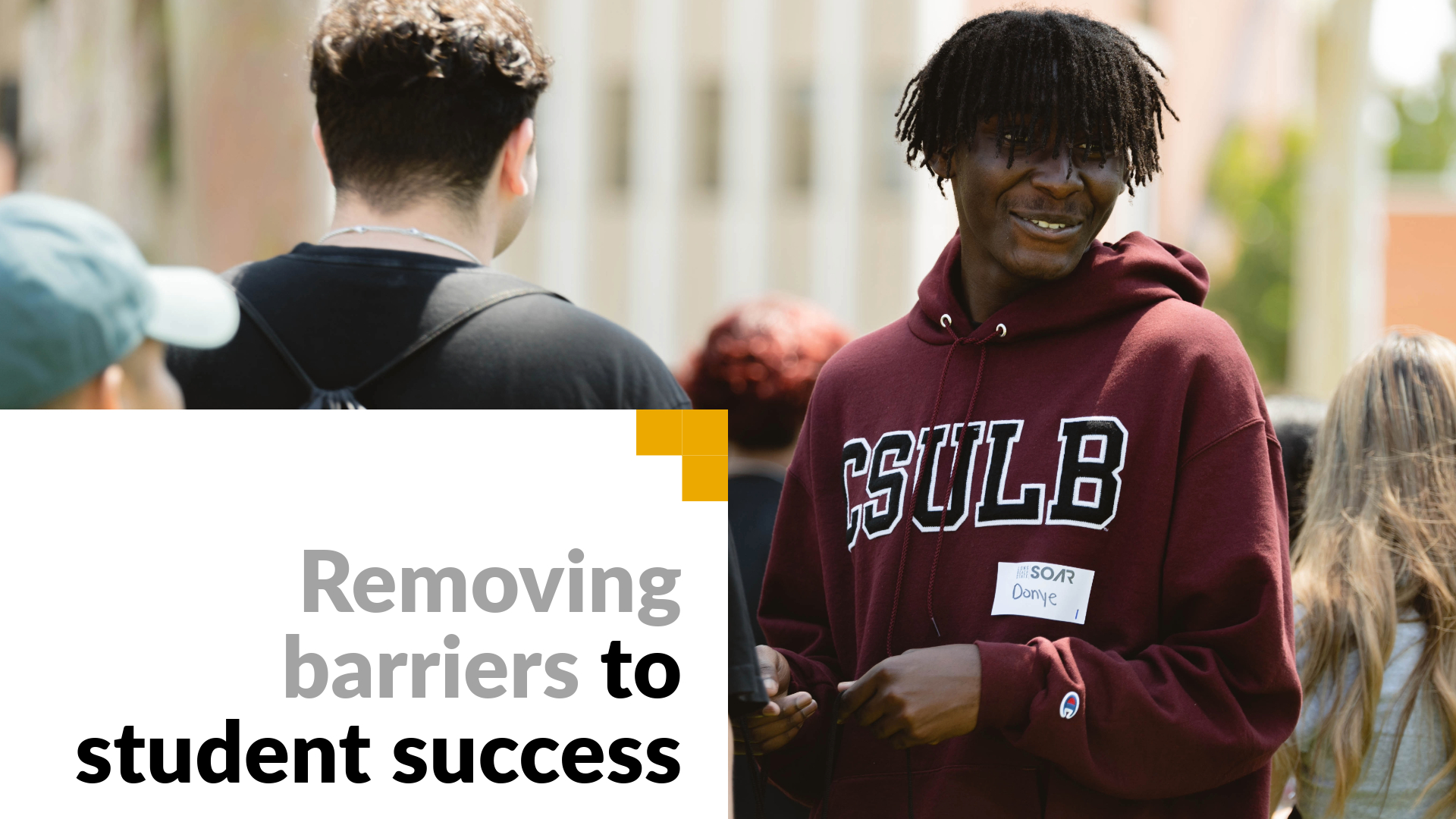 Removing barriers to student success. Image shows a student at orientation.
