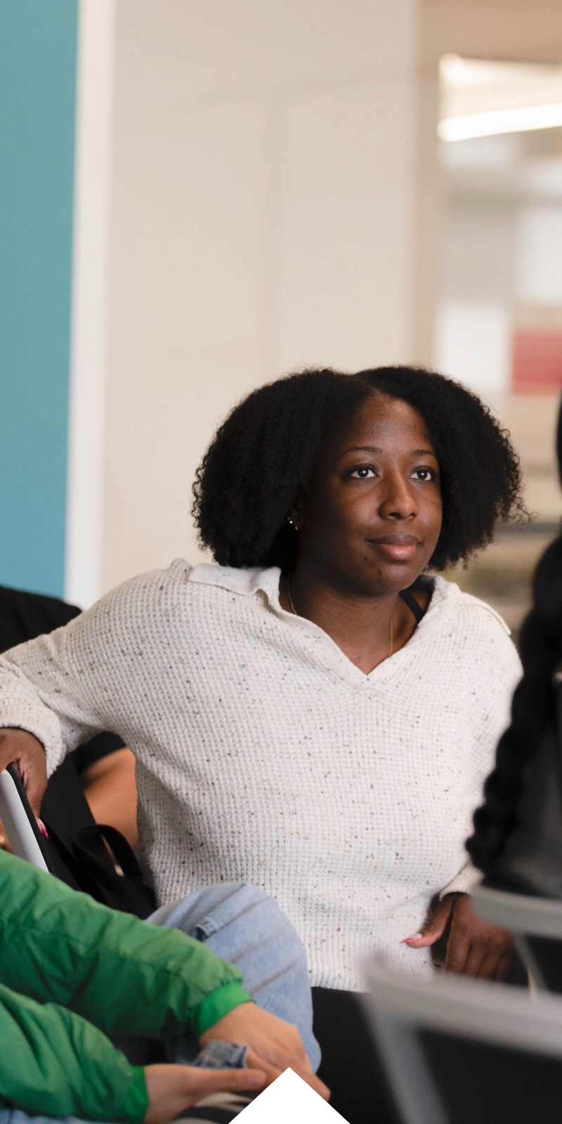 A student looks up attentively in a classroom. 