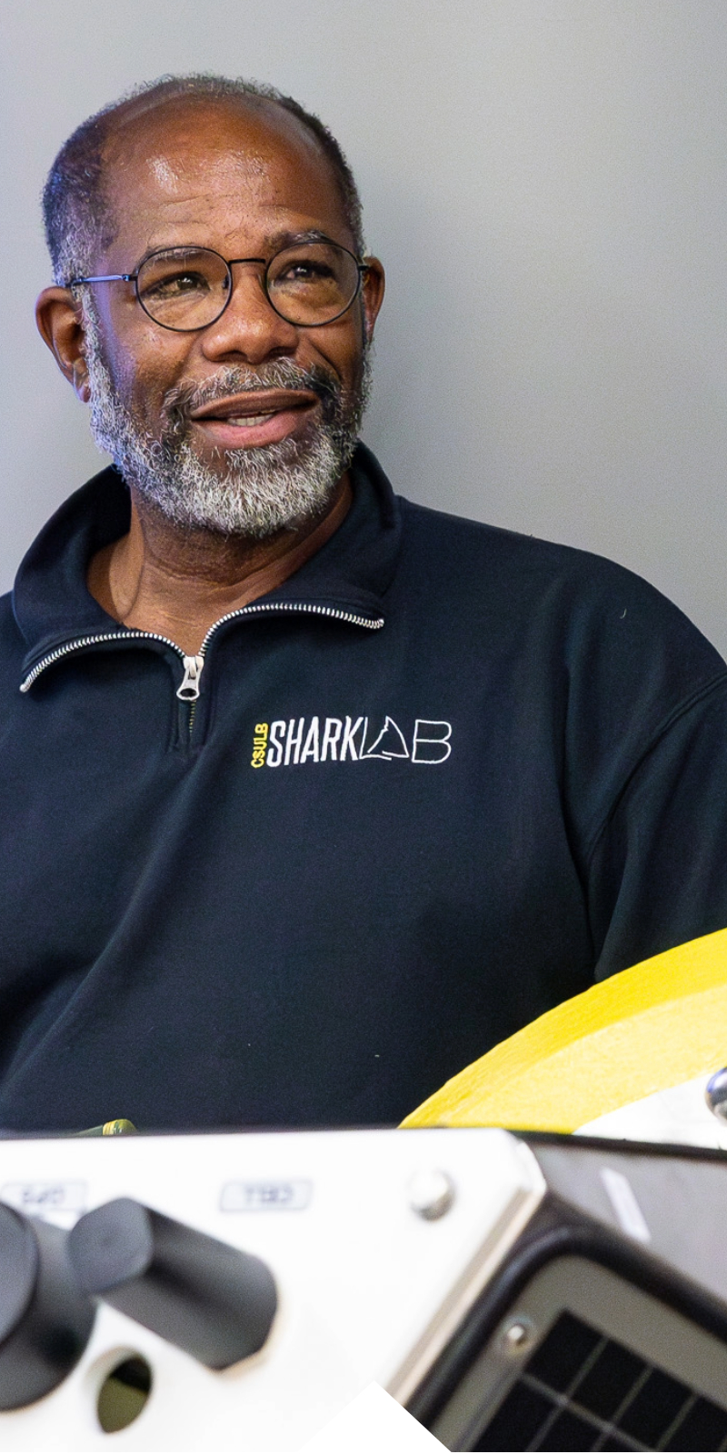 A man in a Shark Lab jacket looks off camera during Science Open House at CSULB. 