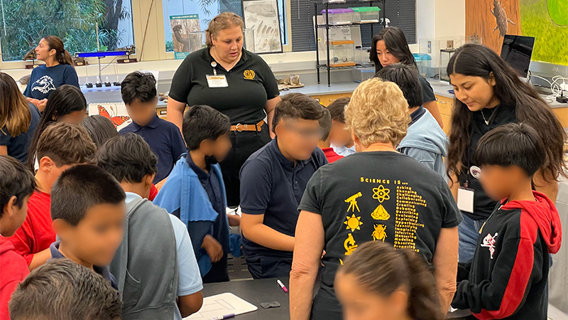 visitors interacting with Science Learning Center staff