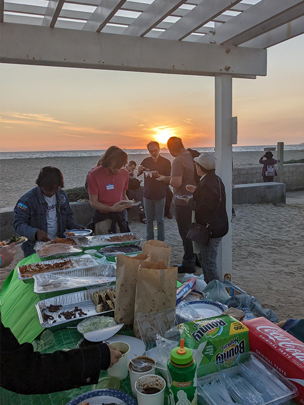 people eating dinner on the beach