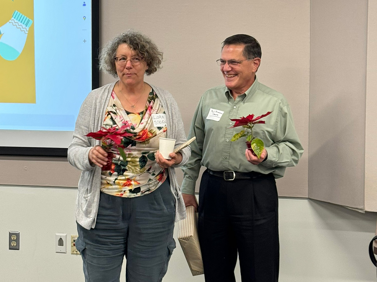 Lora Stevens and Paul Buonora receiving gifts