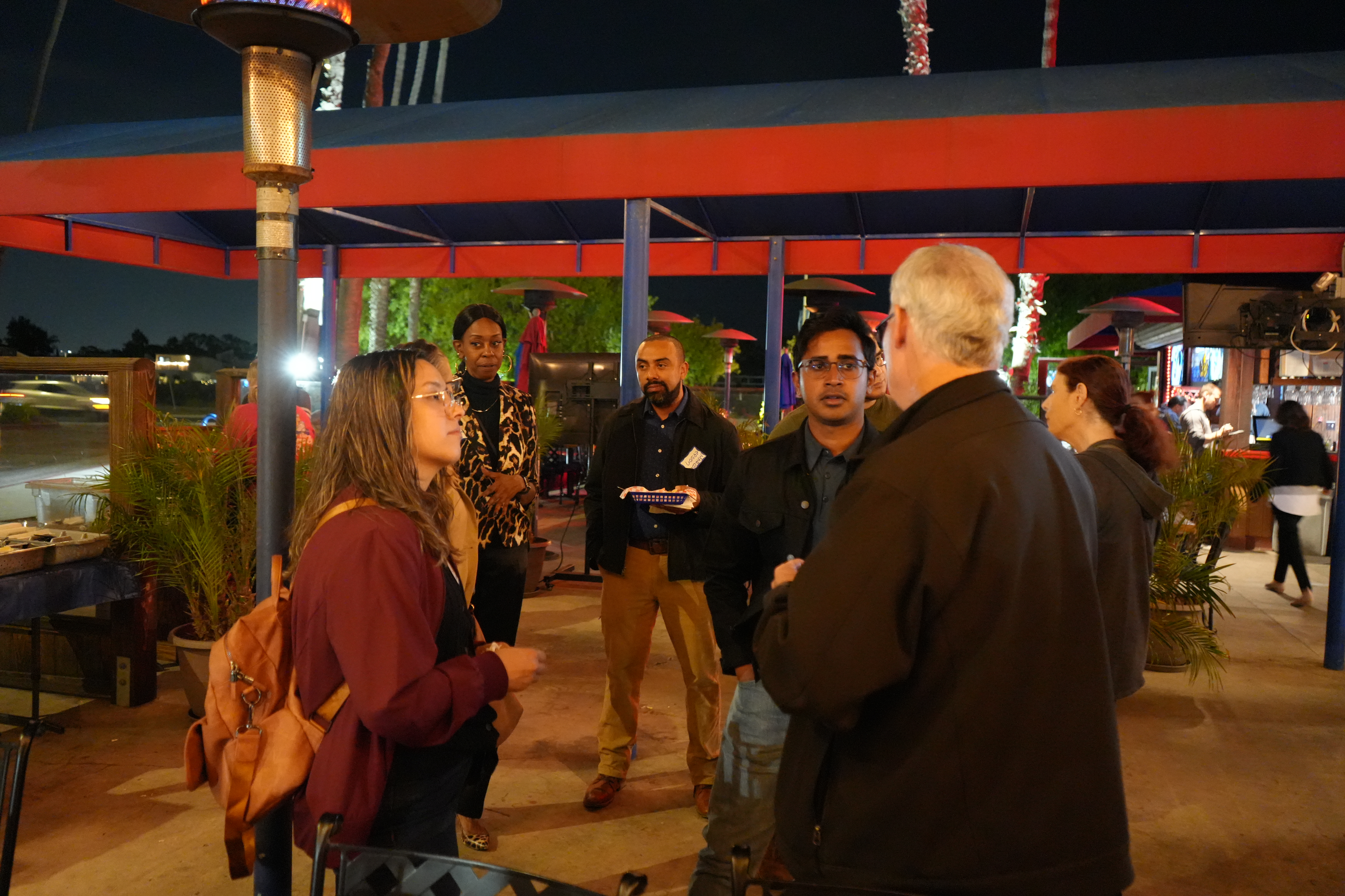 Image of multiple attendees talking to one another at the November mixer at the Crab Pot. 