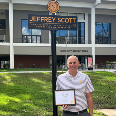 Jeffrey Scott pictured next to Employee of the Month sign