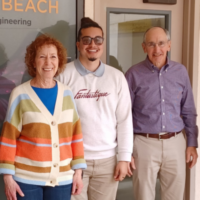 Jo Anne Charmack (left) and her husband, Scott, stand with Christopher Perez (center)