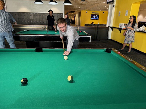 student lining up a pool shot