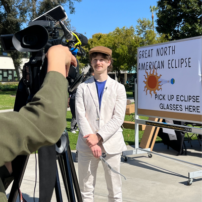 Associate Professor Joel Zinn speaks to press at partial eclipse event