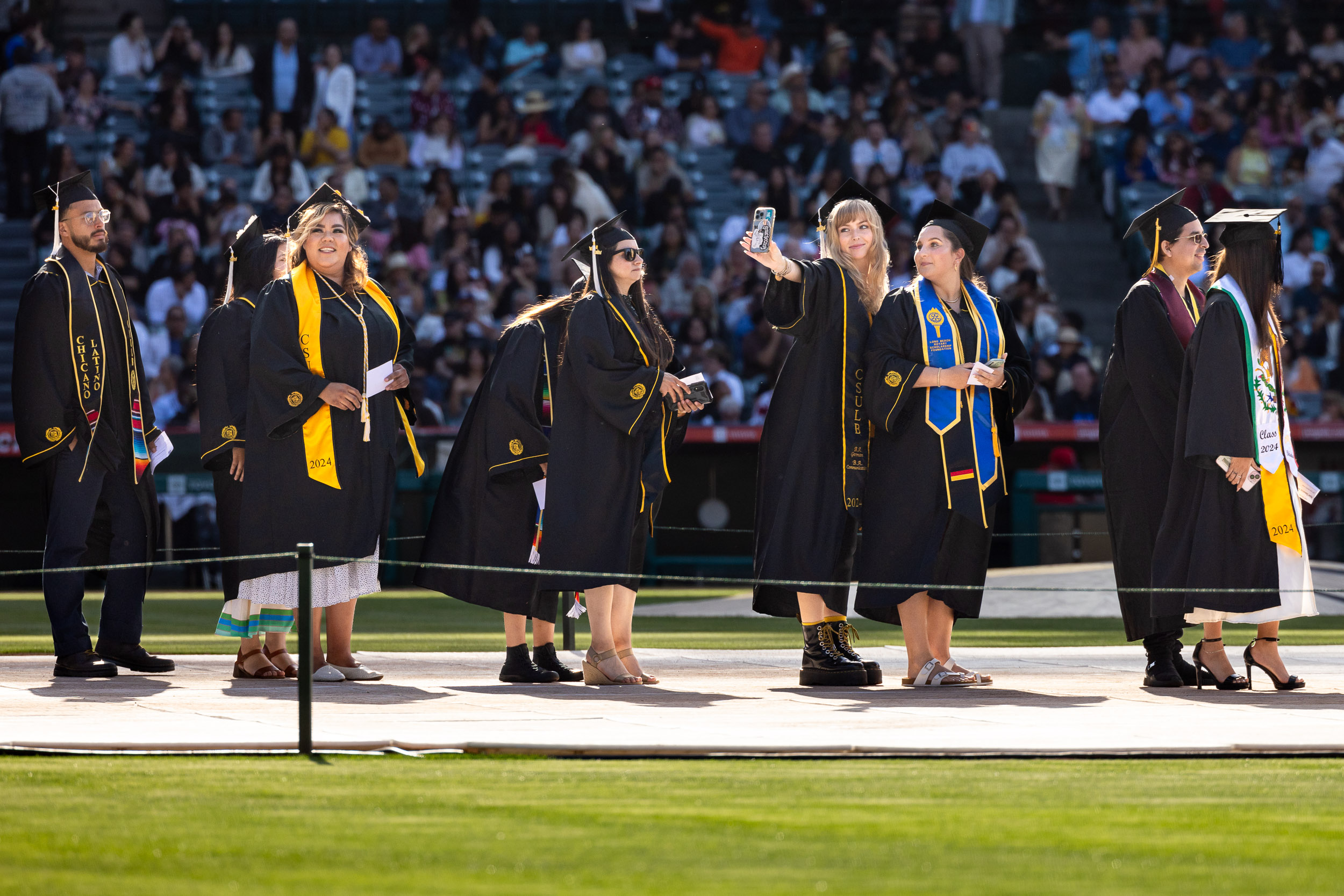 Students lining up to walk on the Commencement stage