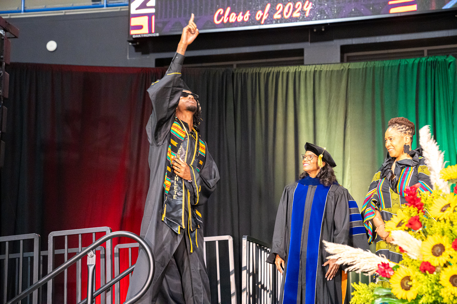 African American graduate pointing upwards onstage African American graduate pointing upwards onstage