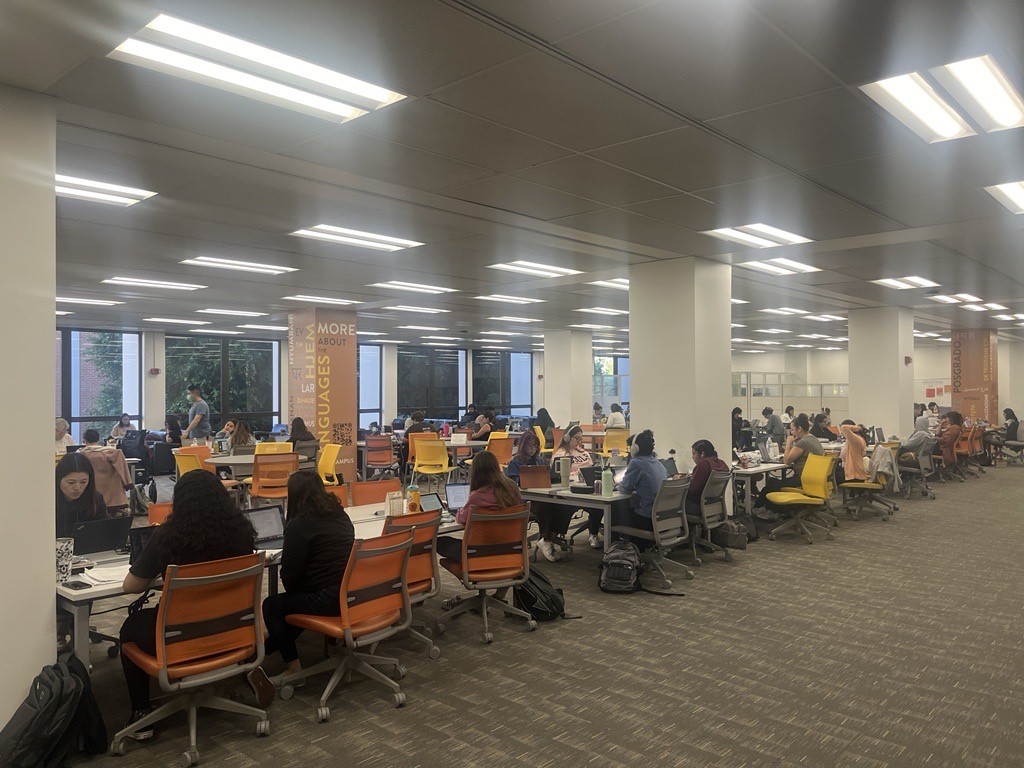 Image of students writing and studying in the library