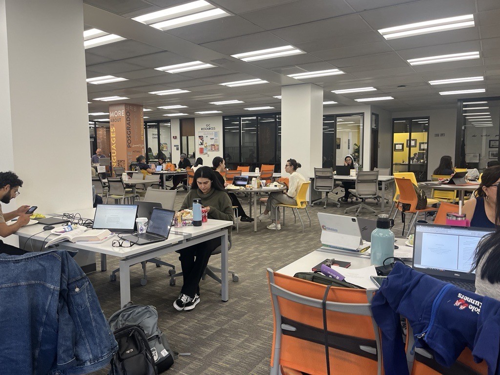 Image of students writing and studying in the library