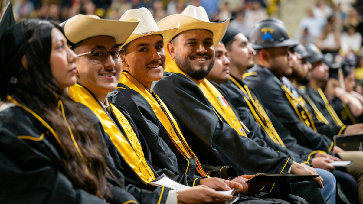 Chicano Latino graduates with cowboy hats Chicano Latino graduates with cowboy hats