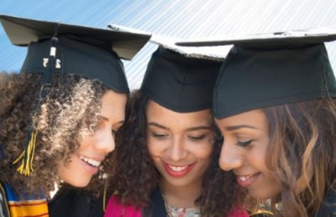 Three students with graduation caps