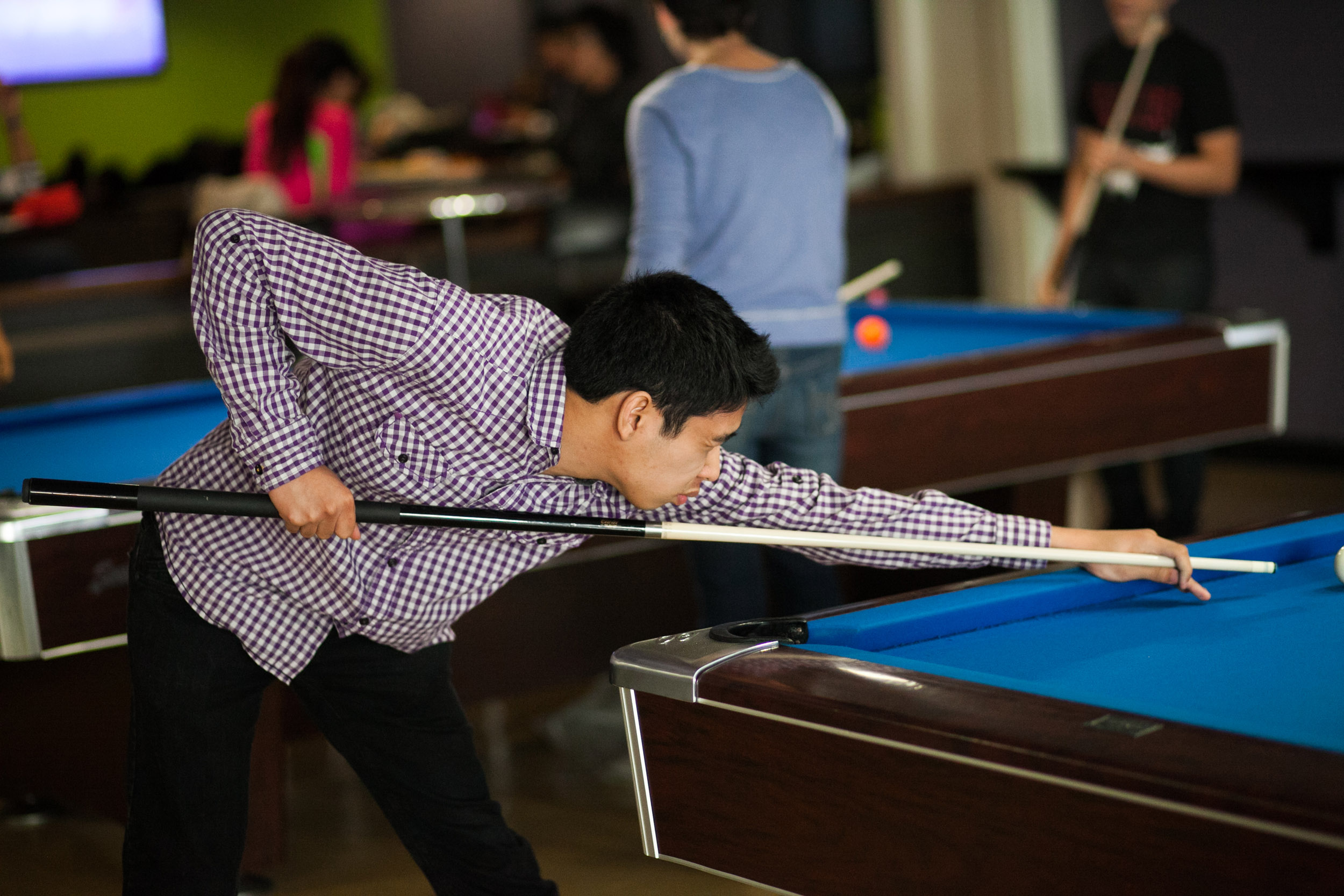A young man shooting pool. A young man shooting pool.
