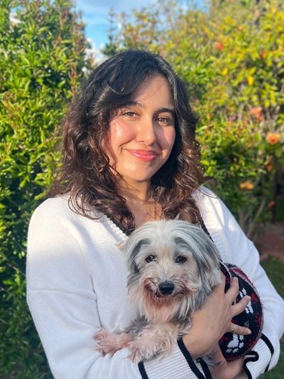 Yasmin Medina Yasmin Medina standing holding a white dog