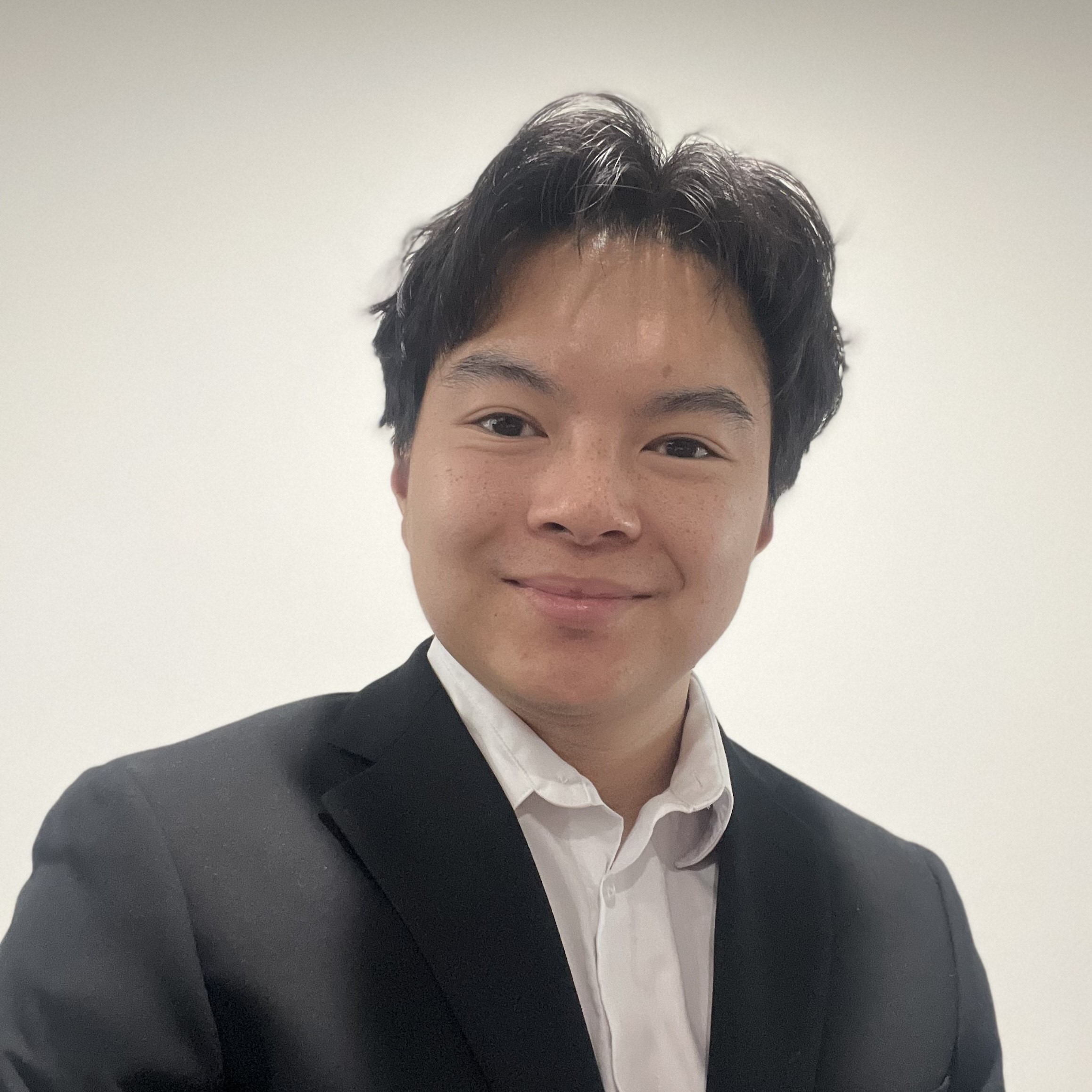 Alan Luong headshot person smiling in suit