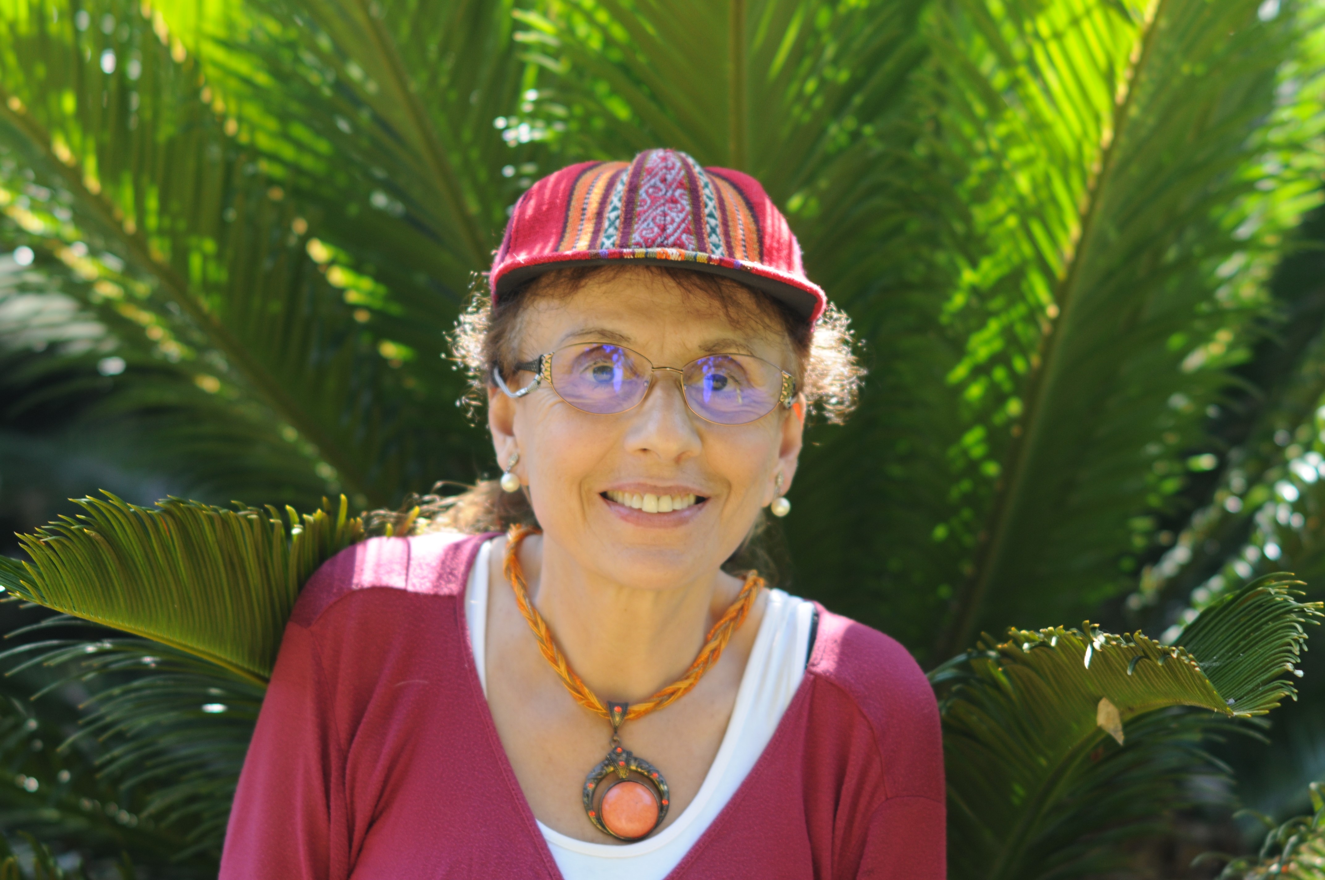 Dr. Elizabeth Dahab woman in front of fern