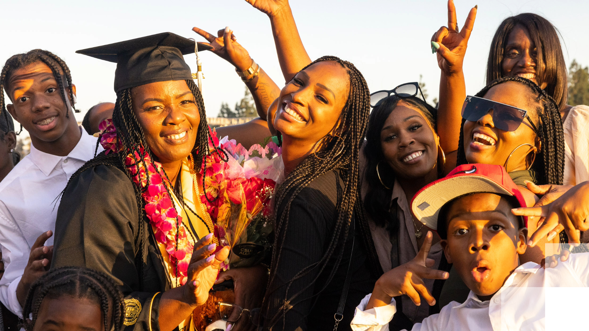 Beach 2030 Beach Journey Two graduates and their families smile after graduation.