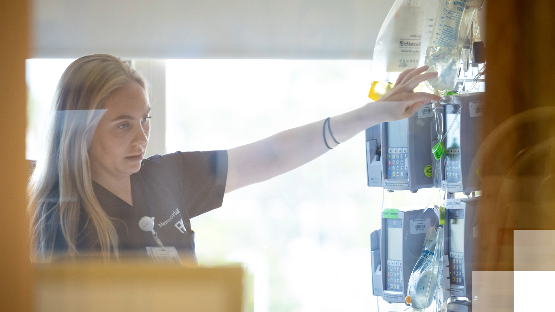 CHHS Nursing - B2030 A nurse reaches for a machine.