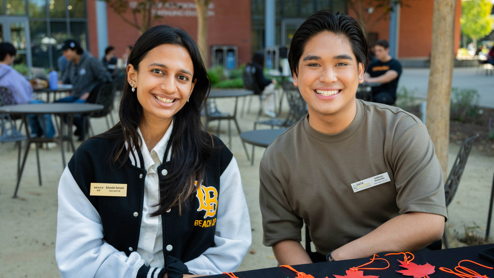 Two students sitting and posing for picture