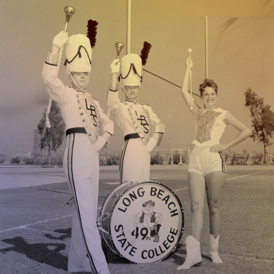Uniformed drum majors with raised batons Uniformed drum majors with raised batons