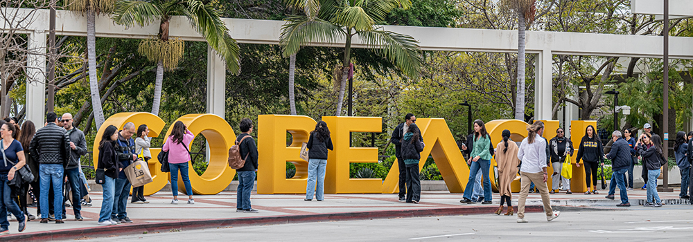 Go Beach Sign DATB People walking by the Go Beach sign