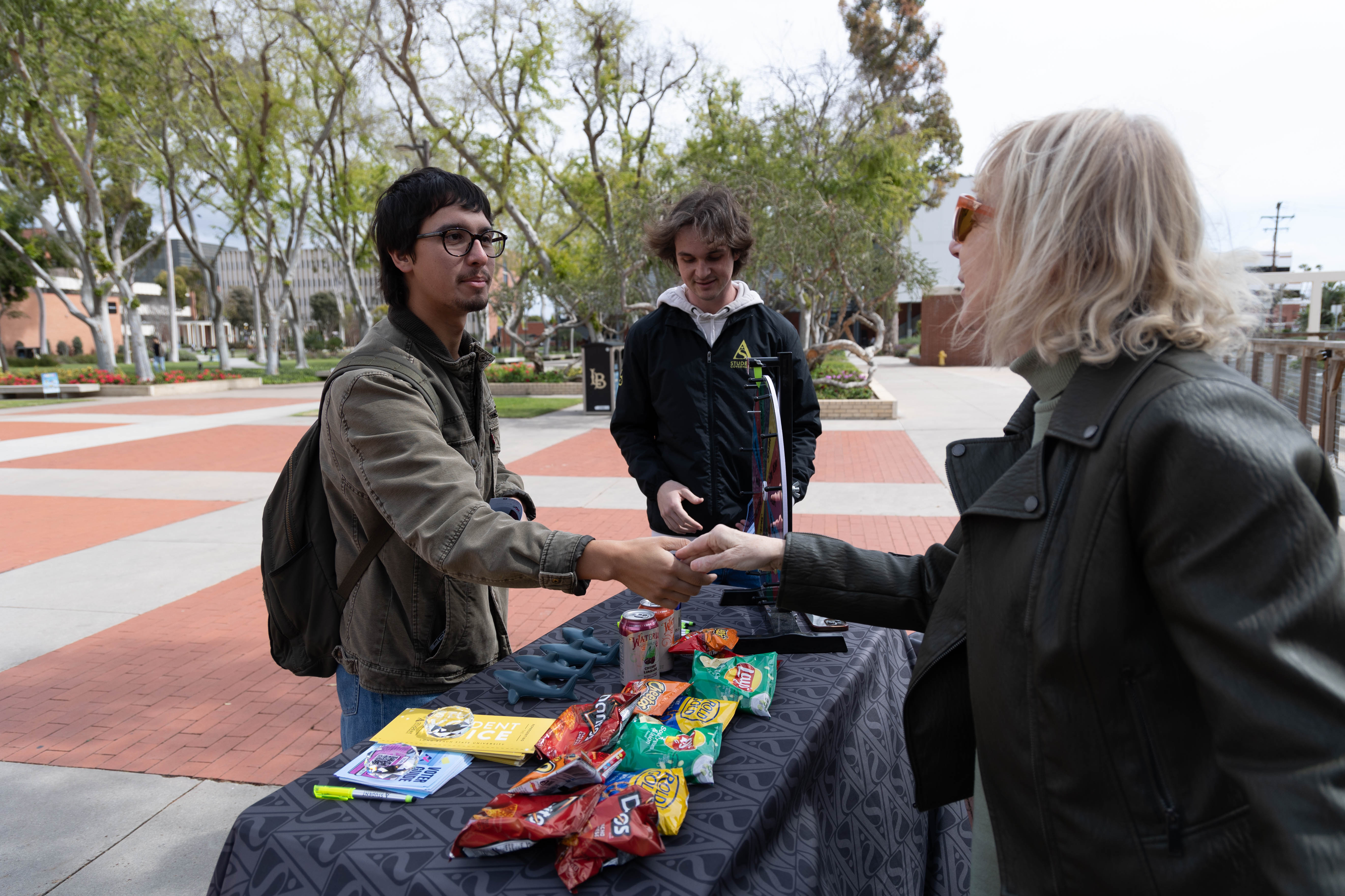 Student shaking hand with dean