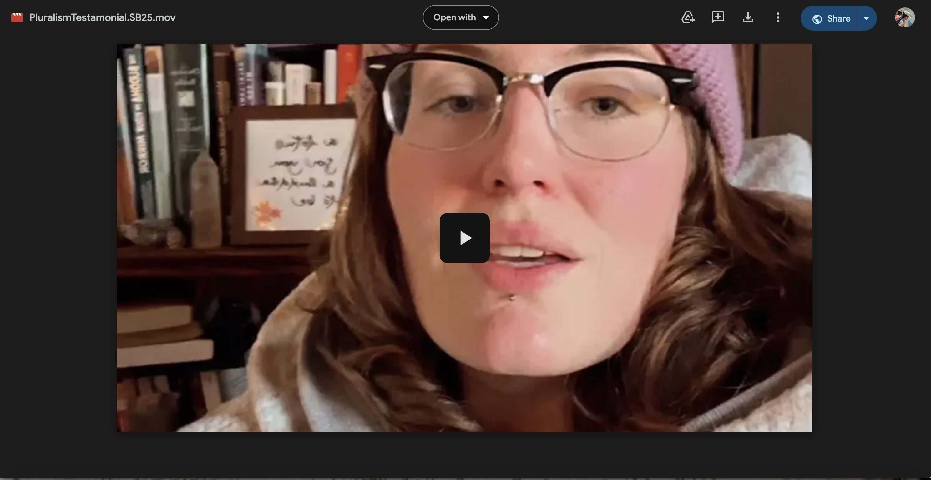 woman's face in front of bookcase