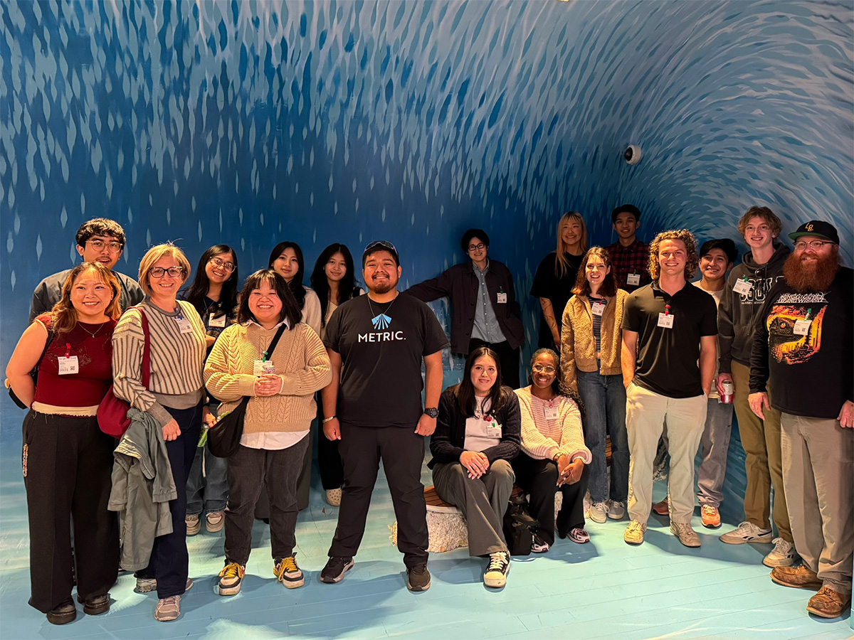 METRIC participants inside room that looks like the interior of an ocean wave
