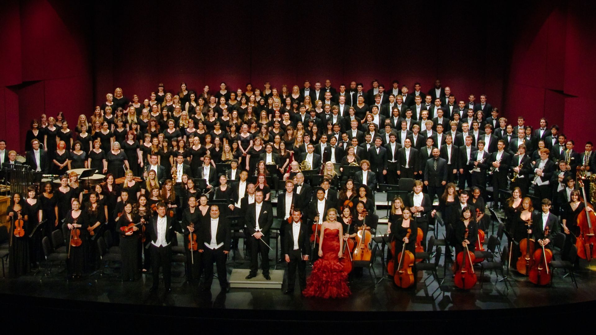 CSULB orchestra and choir in formal attire pose onstage Orchestra and choir in formal attire pose onstage for a group photo