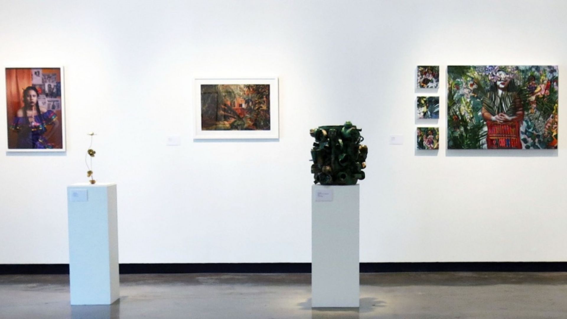 Art gallery wall displays vibrant paintings and sculptures on white pedestals. Art gallery wall displays vibrant paintings and sculptures on white pedestals.