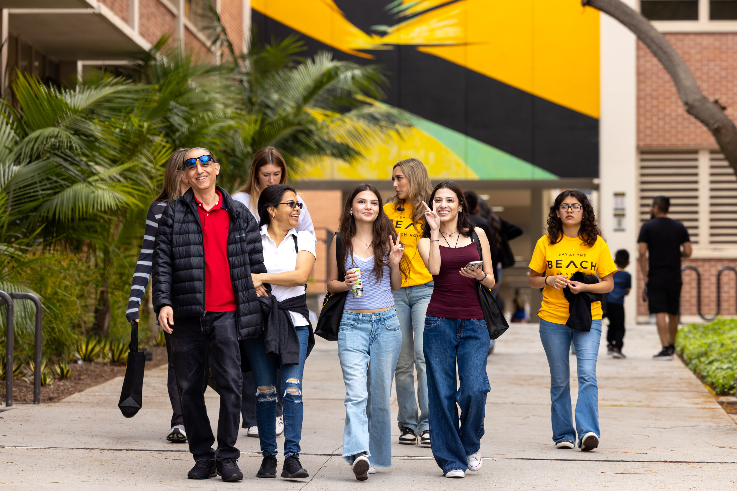 A group of students walking down a sidewalk