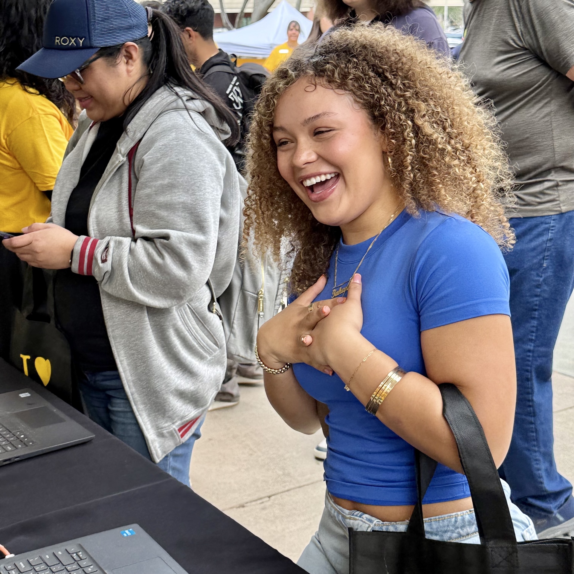 Student in blue shirt laughs 