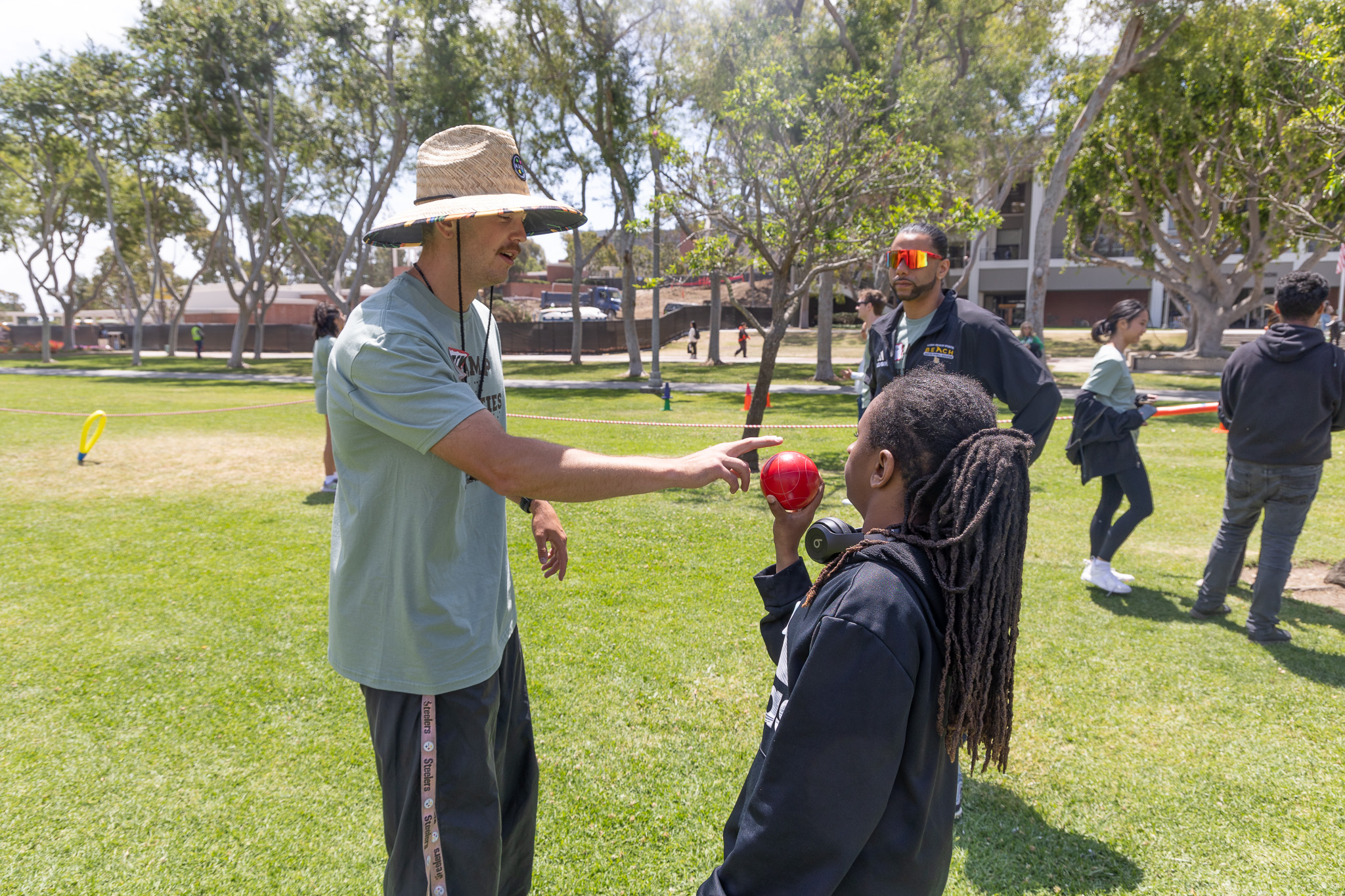 Instructor shows camper red shotput ball